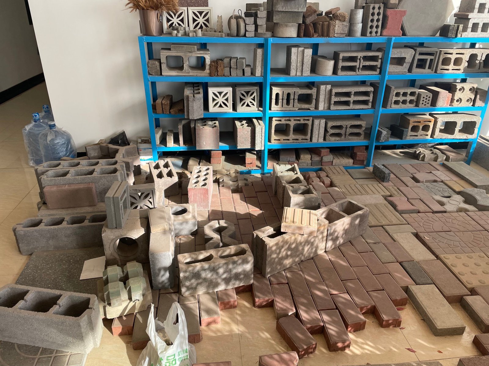 Original photograph of hollow concrete blocks, bricks and paving samples
