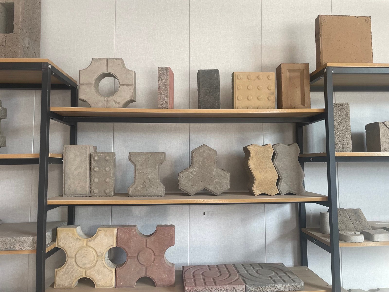 Original photograph of shaped concrete paving blocks and tactile paving samples on display