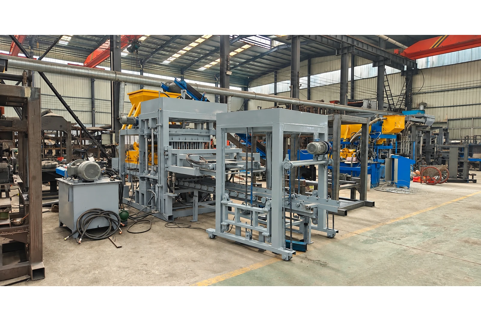 QT4-15 automatic concrete block making machine in a workshop, front angle.